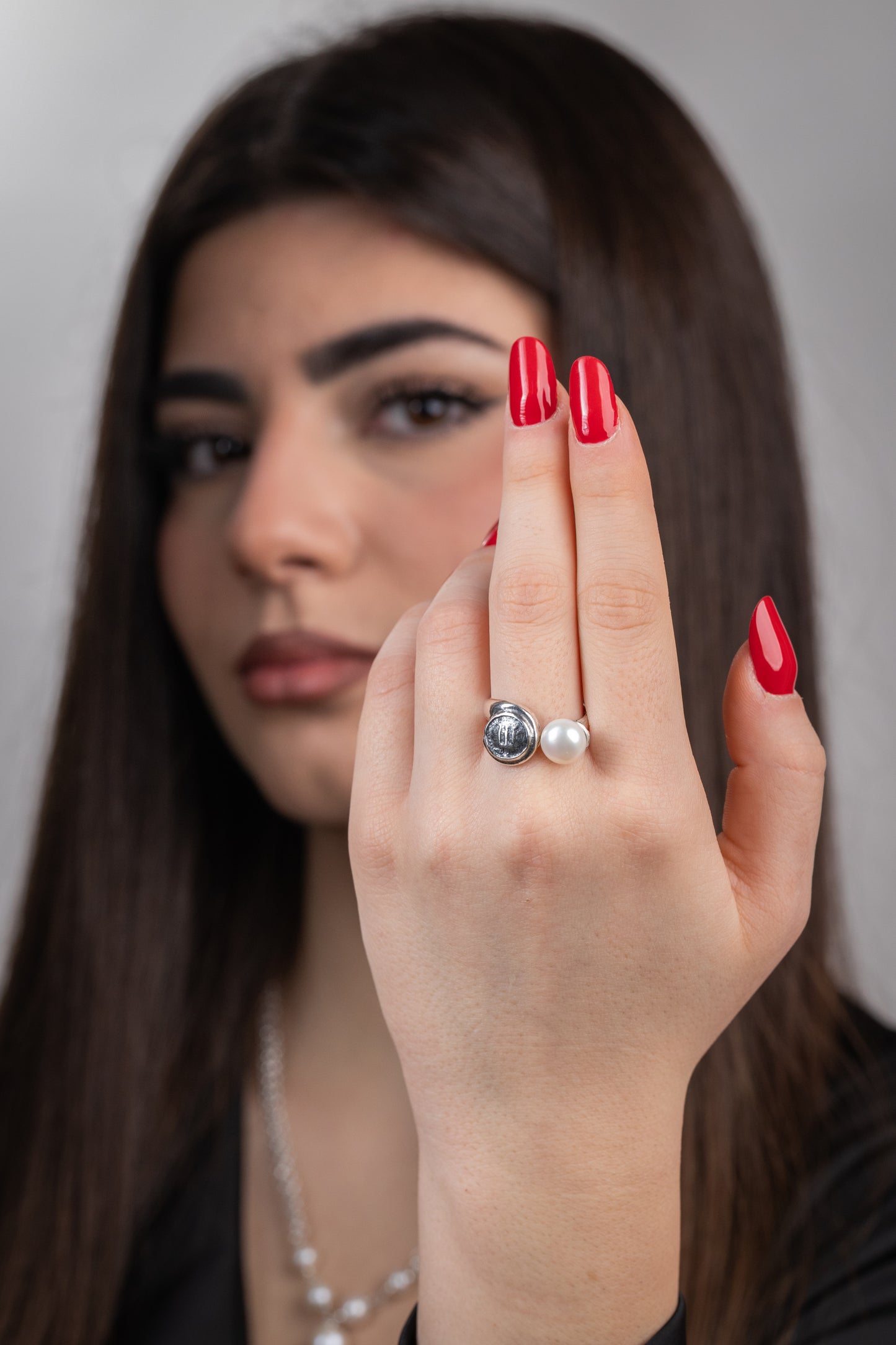 Anello in argento 925 con statere di Kroton e perla coltivata d'acqua dolce indossato al dito